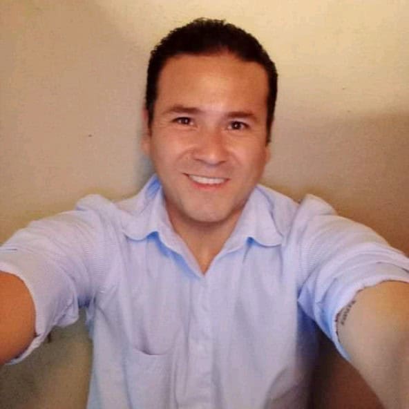 Smiling man in light blue shirt taking a selfie for HireSDRs.